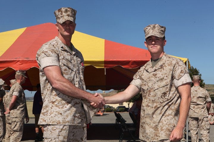 Capt. James Ferguson congratulates Sgt. Josh Frasier on receiving the Bronze Star with Combat V Captain James Ferguson presents Sgt. Josh Frasier with the Bronze Star Medal with Combat V at Camp Pendleton
