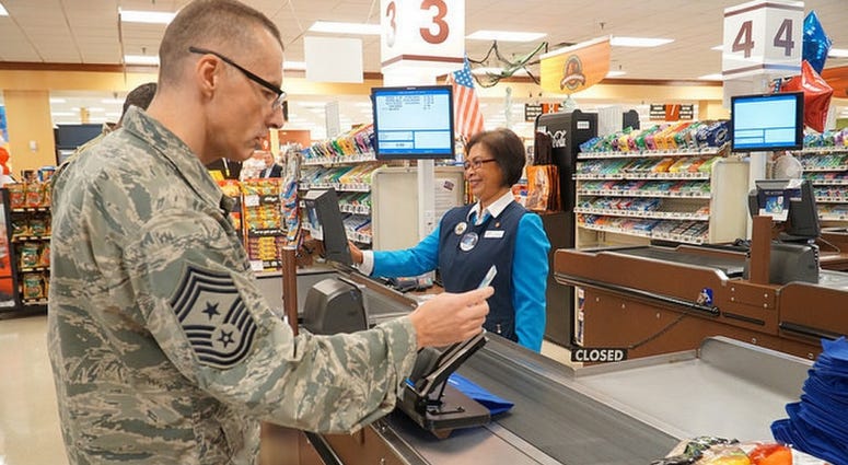 Chief Master Sgt. Stuart Allison, DeCA senior enlisted advisor, swipes a MILITARY STAR card at the commissary at Oct. 5, 2017 at Fort Lee, Va.