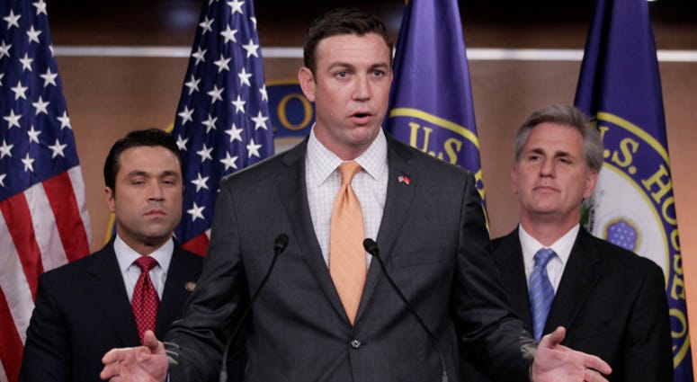 FILE - In this April 7, 2011 file photo, U.S. Rep. Duncan Hunter, R-Calif., center, speaks during a news conference on Capitol Hill. A federal grand jury in California on Tuesday, Aug. 21, 2018, has indicted Rep. Duncan Hunter and his wife on corruption c