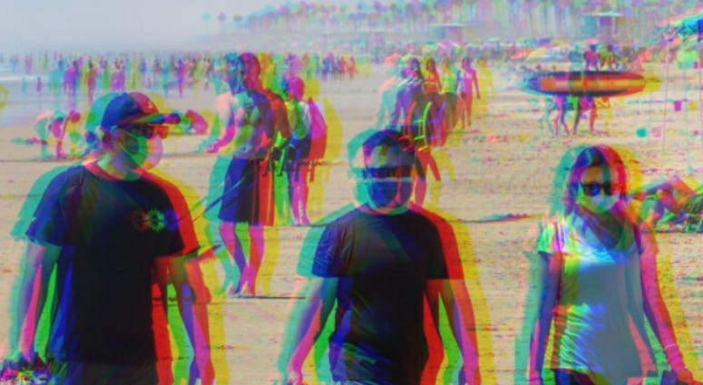 People wearing masks on the beach in California People wearing masks on the beach in California