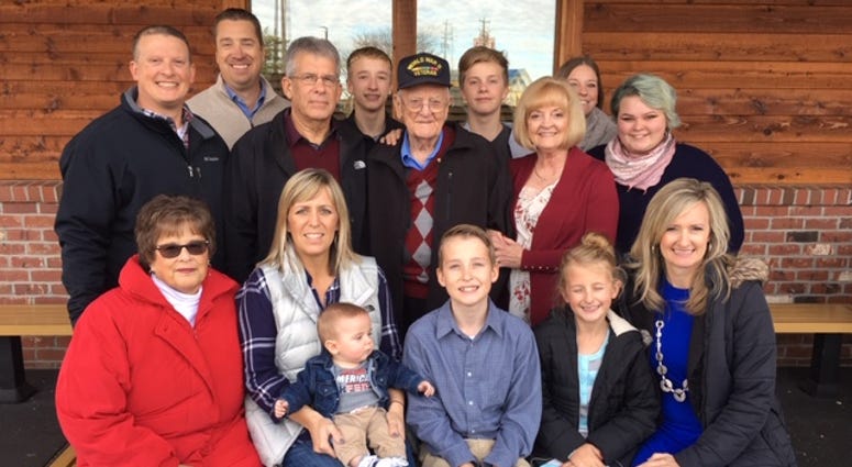 94-year-old Earl Bailey surrounded by family after receiving his awards from World War II.