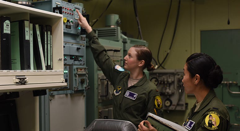 Second Lt. Alexandra Rea, 490th Missile Squadron ICBM combat crew deputy director, left, and 1st Lt. Elizabeth Guidara, 12th Missile Squadron combat crew deputy director, perform training at the Malmstrom Air Force Base, Mont. Building 500 Missile Procedu