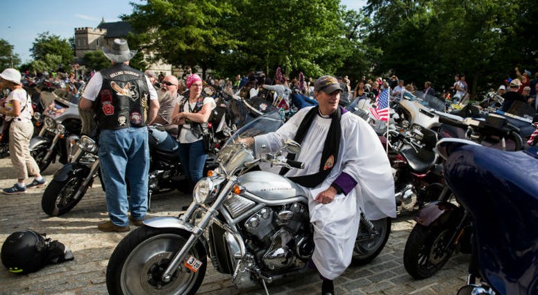Rev. Stuart Kenworthy sits on a motorcycle during a blessing of the bikes event at the Washington National Cathedral. Memorial Day weekend across America.