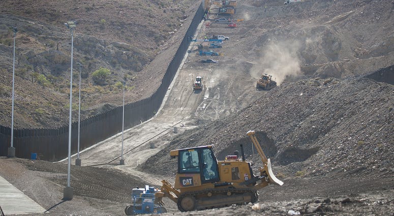 Construction crews work on a border wall being put in place by We Build The Wall Inc. in Sunland Park, New Mexico. Construction crews work on a border wall being put in place by We Build The Wall Inc. in Sunland Park, New Mexico.