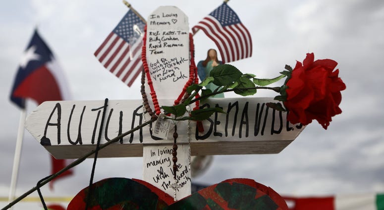 A cross honoring Arturo Benavides, 60, stands at a makeshift memorial for victims outside Walmart, near the scene of a mass shooting which left at least 22 people dead, on August 6, 2019 in El Paso, Texas. ElPasoBenavides