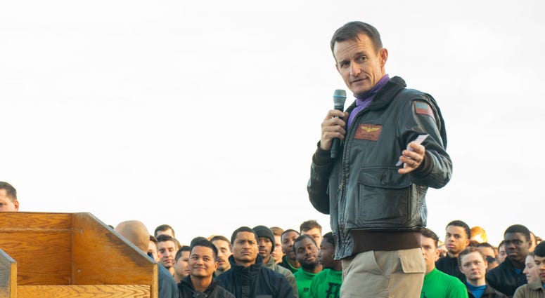 In this handout released by the U.S. Navy, Capt. Brett Crozier, commanding officer of the aircraft carrier USS Theodore Roosevelt (CVN 71), gives remarks during an all-hands call on the ships flight deck Dec. 15, 2019. In this handout released by the U.S. Navy, Capt. Brett Crozier, commanding officer of the aircraft carrier USS Theodore Roosevelt (CVN 71), gives remarks during an all-hands call on the ships flight deck Dec. 15, 2019.