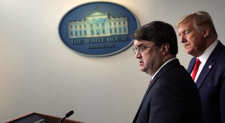 U.S. Secretary of Veterans Affairs Robert Wilkie speaks as President Donald Trump listens during a news briefing on the latest development of the coronavirus outbreak in the U.S. at the James Brady Press Briefing Room at the White House March 18, 2020. WilkieTrump