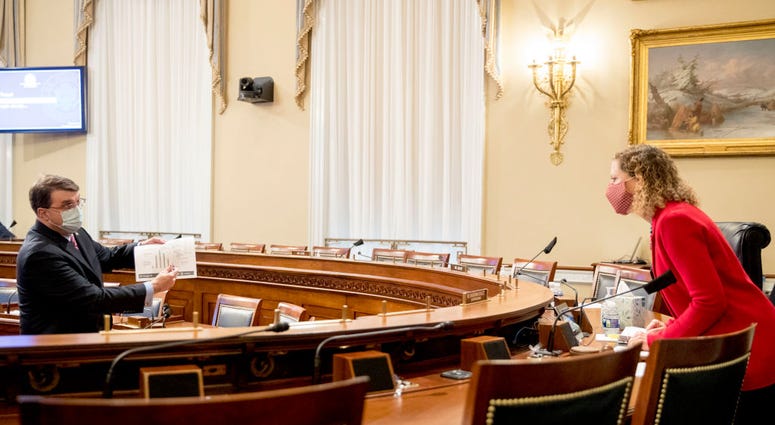 Veterans Affairs Secretary Robert Wilkie, left, holds up a document titled Hydroxychloroquine Timeline and Utilization as he speaks with Chairwoman Rep. Debbie Wasserman Schultz (D-FL) during a House Appropriations Subcommittee hearing on Capitol Hill. Veterans Affairs Secretary Robert Wilkie, left, holds up a document titled Hydroxychloroquine Timeline and Utilization as he speaks with Chairwoman Rep. Debbie Wasserman Schultz (D-FL) during a House Appropriations Subcommittee hearing on Capitol Hill.