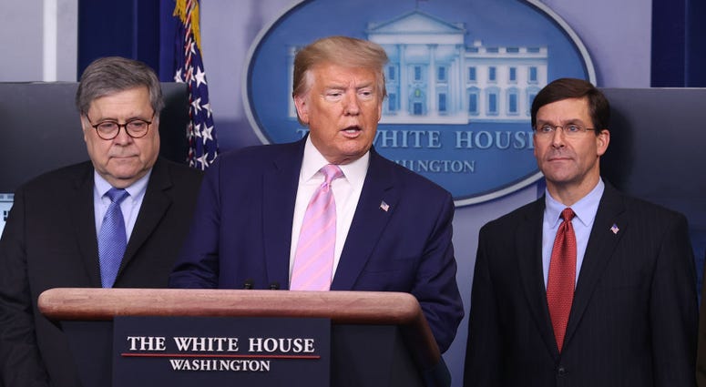 President Donald Trump speaks during a coronavirus press briefing flanked by Attorney General William Barr and Defense Secretary Mark Esper April 1, 2020 in Washington, DC Trump