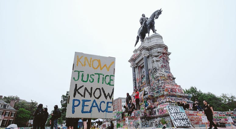 A No justice no peace sign stands at the Robert E. Lee monument on June 20, 2020 in Richmond, Virginia. Protesters for racial justice have called for statues of Confederate leaders, like Lee, be taken down. A No justice no peace sign stands at the Robert E. Lee monument on June 20, 2020 in Richmond, Virginia. Protesters for racial justice have called for statues of Confederate leaders, like Lee, be taken down.