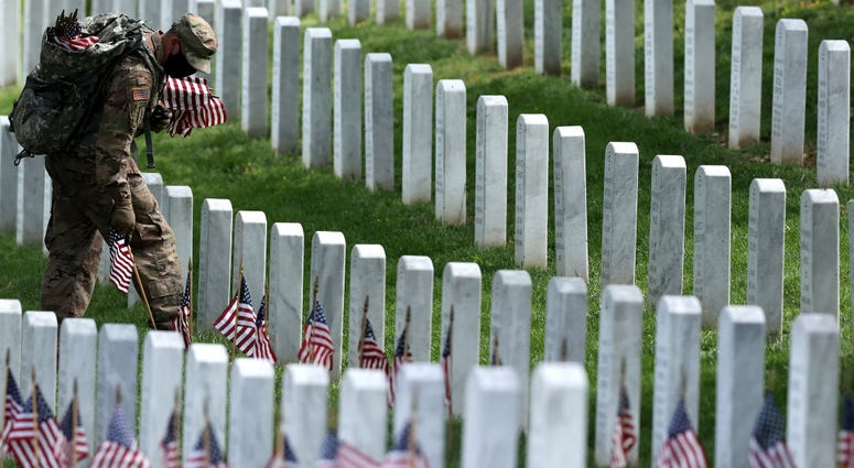 Wearing face masks to reduce the risk of spreading the novel coronavirus, soldiers from the 3rd Infantry Regiment, also called the "Old Guard," place U.S. flags in front of every grave site ahead of the Memorial Day weekend in Arlington National Cemetery. Wearing face masks to reduce the risk of spreading the novel coronavirus, soldiers from the 3rd Infantry Regiment, also called the "Old Guard," place U.S. flags in front of every grave site ahead of the Memorial Day weekend in Arlington National Cemetery.