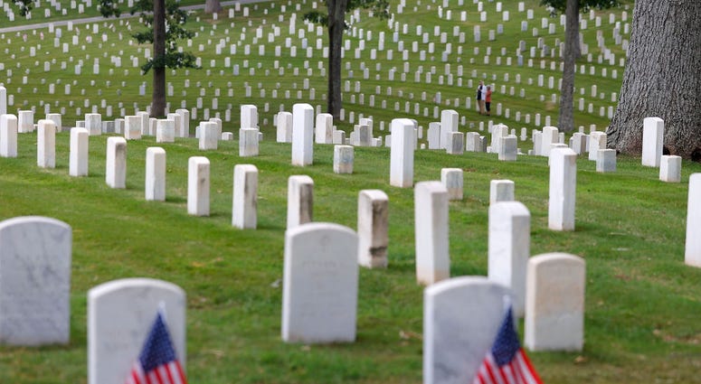 A couple stands amongst the graves in Marietta National Cemetery on Memorial Day, May 25, 2020 in Marietta, Georgia. A couple stands amongst the graves in Marietta National Cemetery on Memorial Day, May 25, 2020 in Marietta, Georgia.