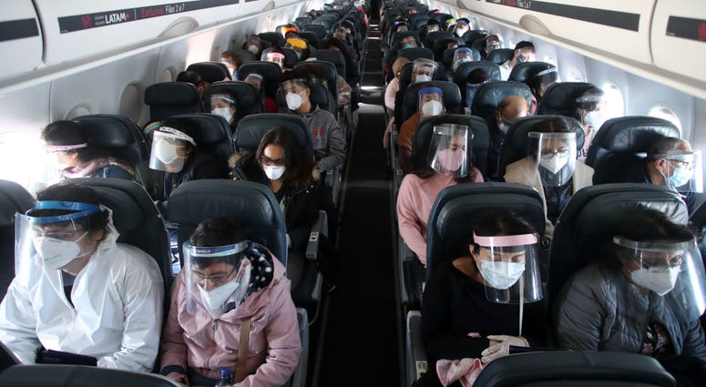Passengers wearing face shields remain seated during the LA 2212 flight between Lima and Trujillo, Peru on July 15, 2020. Passengers wearing face shields remain seated during the LA 2212 flight between Lima and Trujillo, Peru on July 15, 2020.