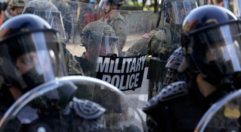 Law enforcement officers and members of the National Guard monitor a protest on June 1, 2020 in downtown Washington, DC. Law enforcement officers and members of the National Guard monitor a protest on June 1, 2020 in downtown Washington, DC.
