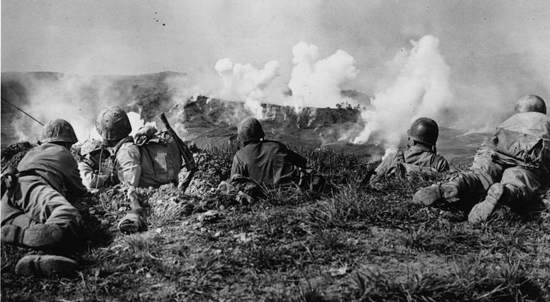 US Marines of the 1st Division wait on the crest of a hill in southern Okinawa, as they watch phosphorous shells explode over Japanese soldiers dug into the hills. US Marines of the 1st Division wait on the crest of a hill in southern Okinawa, as they watch phosphorous shells explode over Japanese soldiers dug into the hills.