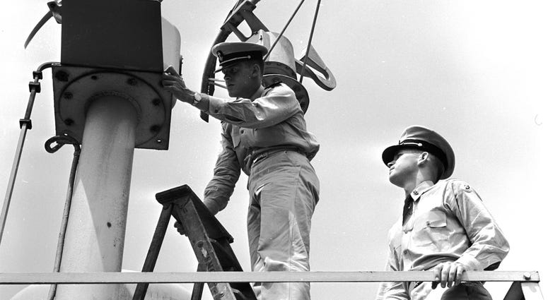 Circa 1955: A cadet-midshipman inspecting a radar scanner on top of Bowditch Hall at the United States Merchant Marine Academy at Kings Point, New York. MerchantMarine