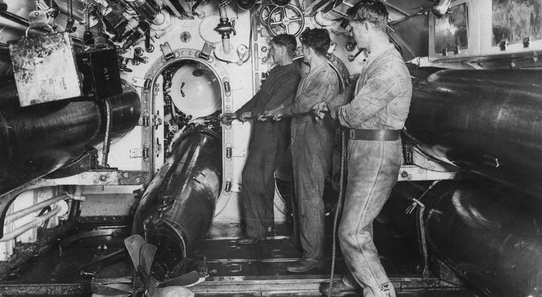 British submariners load a torpedo