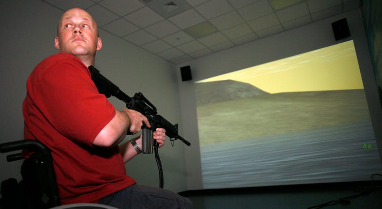 SAN ANTONIO, TX - MARCH 1: Petty Officer 2nd Class Chad Keuser, 33, uses a mock M4 assault rifle in simulator at the new high tech Center for the Intrepid rehab center for wounded veterans at Brooke Army Medical Center March 1, 2007 in San Antonio, Texas. Navy vet Chad Keuser uses a mock M4 assault rifle in simulator at the new high tech Center for the Intrepid rehab center for wounded veterans at Brooke Army Medical Center March 1, 2007 in San Antonio, Texas.