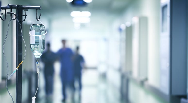 Group of doctors in a hurry down the hospital hallway for emergency Group of doctors in a hurry down the hospital hallway