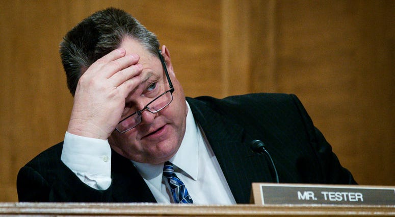 Senator Jon Tester (D-MT) looks on as Treasury Secretary Steven Mnuchin delivers the annual financial stability report to the Senate Banking, Housing and Urban Affairs Committee on January 30, 2018 in Washington, DC. JonTester