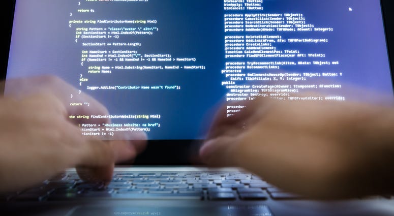 Close-up Of A Hacker's Hand Using Laptop Data Breach of Combat Veterans