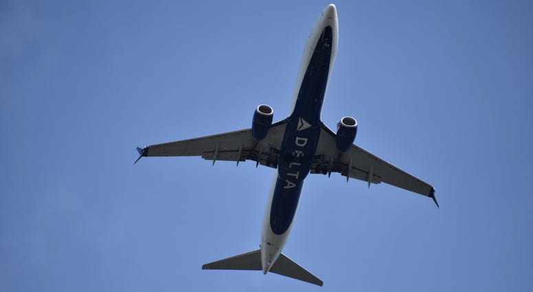 Delta Airline Aircraft Ascending into Blue Sky