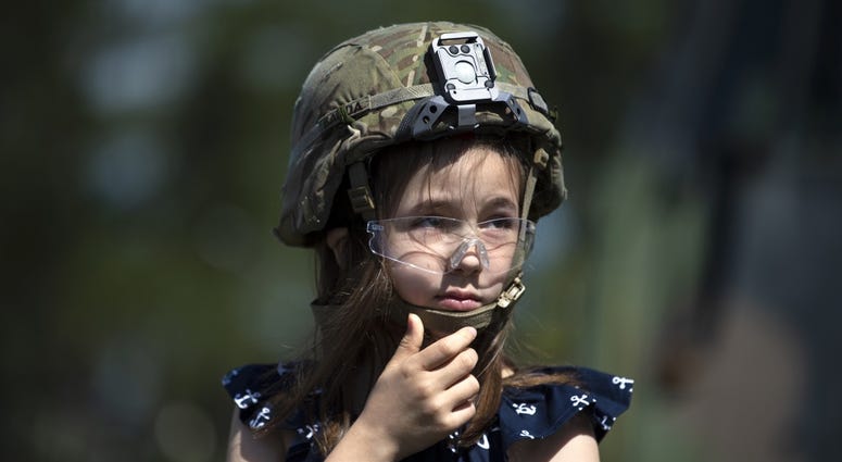 Gold Star family member Jamie Nolen wears a soldier’s helmet while visiting Fort Bragg, N.C. with NASCAR driver Ryan Newman April 17, 2019. Jamie Nolen is the daughter of Sgt. James Nolen, who died while serving in Afghanistan in 2009. GoldStarFamily