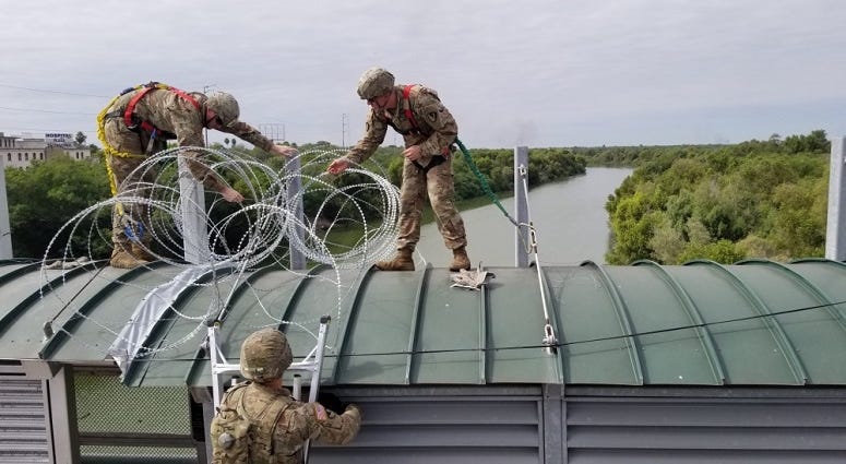 Soldiers deploy concertina wire in a location along the Southwest border of the United States near Hidalgo, Texas.