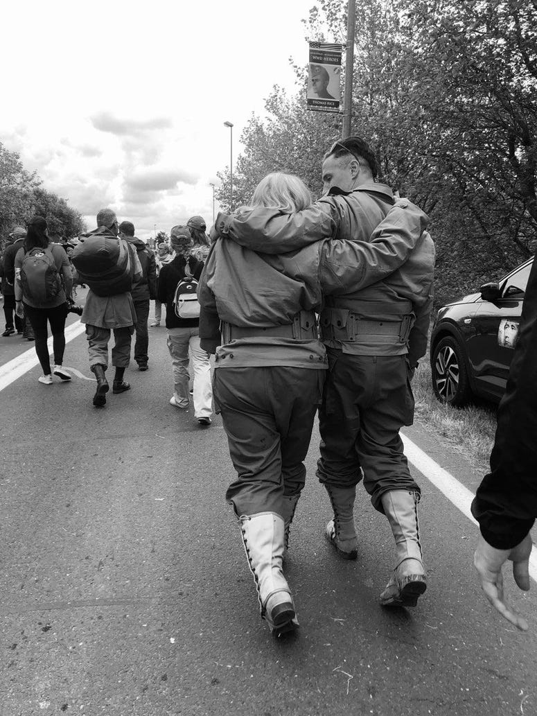 Scoti Domeij and Griff walk together after their jump in to Normandy Gold Star mom Scoti Domeij and Matthew Griffin, who served with her son Kristoffer after jumping in to Normandy.