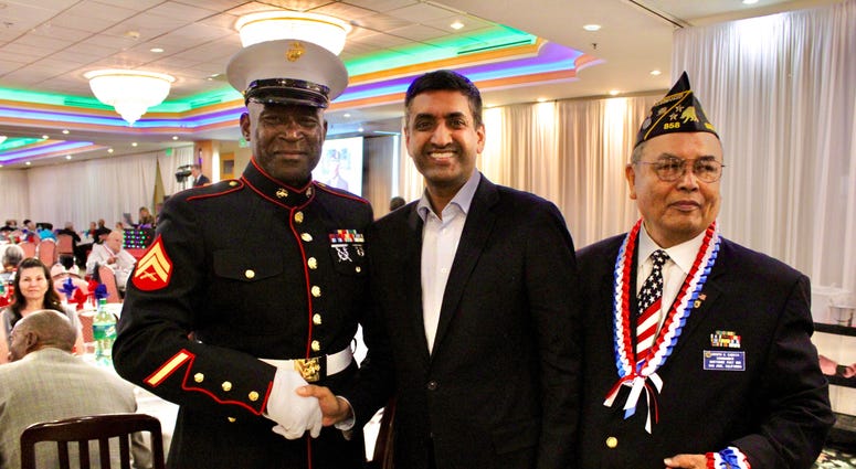 Rep. Ro Khanna, D-Calif., poses for a photo with two veterans. Khanna