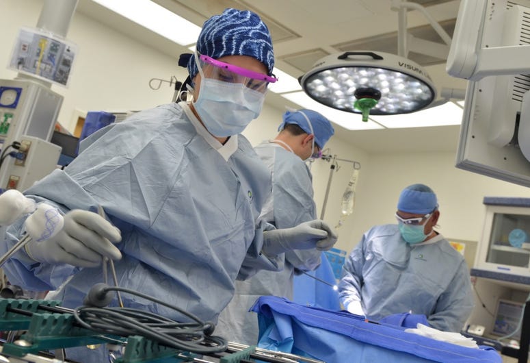 Hospitalman Scarlett Vigil, a surgical technician at Naval Hospital Jacksonville, retrieves instruments for surgeons during a laparoscopy in the O.R. Vigil, a native of Midland, Texas MilitaryMedical