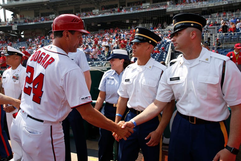 Nationals First Base Coach Tim Bogar greets military members honored before the game Nationals First Base Coach Tim Bogar greets military members honored before the game