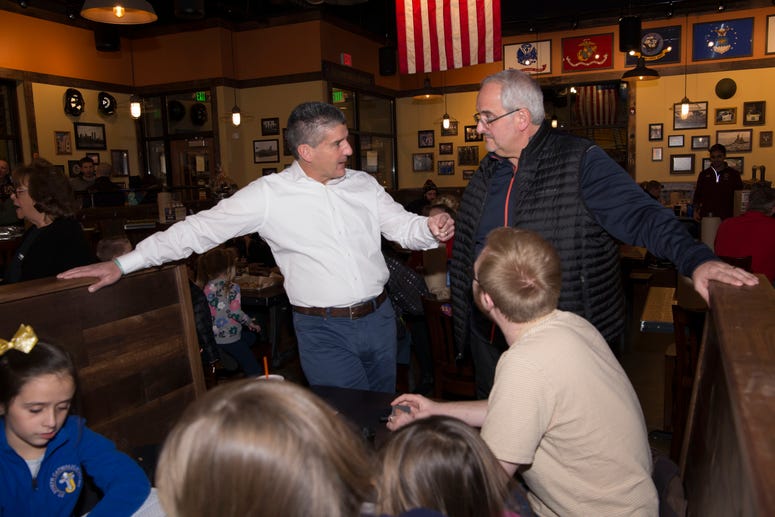 Mission BBQ Co-Founder Bill Kraus (white shirt) speaks to a customer at a Kenosha, WI Fire Night event
