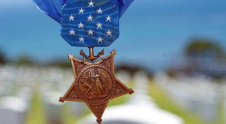 The Medal of Honor hangs in the air.