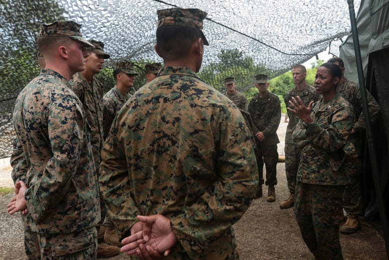 U.S. Marines with Marine Aircraft Control Group 18 listen to Colonel Lorna Mahlock, commanding officer, MACG-18, during Exercise Valiant Shield 16, Sept. 14, 2016. Mahlock visited with the MACG-18 Marines on Tinian and site surveyed their camp and workspa Brigadier General Lorna Mahlock