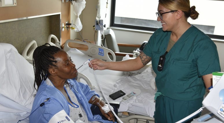Army 1st Lt. Gabrielle Williams, a nurse in 4-West, cares for a patient at Walter Reed National Military Medical Center. MilitaryHospital