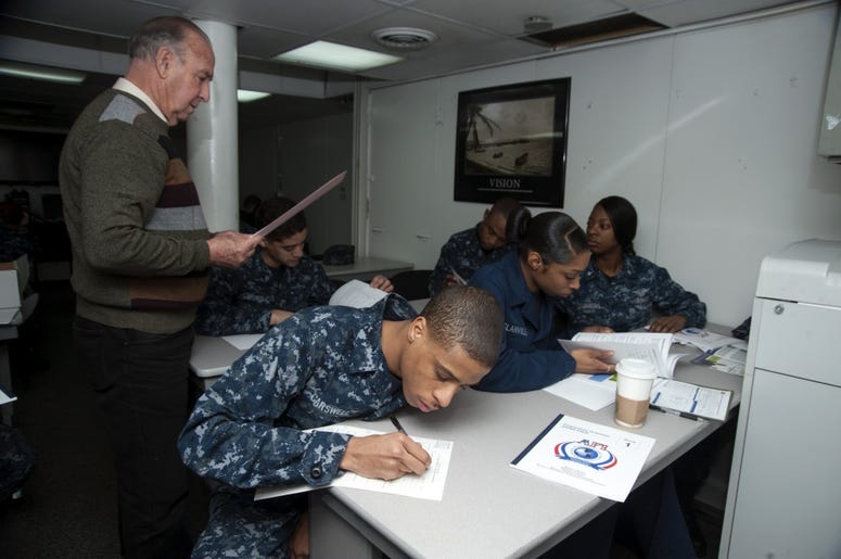 Yeoman Seaman Rhondal Carswell works on math problems during the first day of the Navy College Program for Afloat College Education (NCPACE) academic skills math course aboard the aircraft carrier USS Harry S. Truman (CVN 75). NCPACE