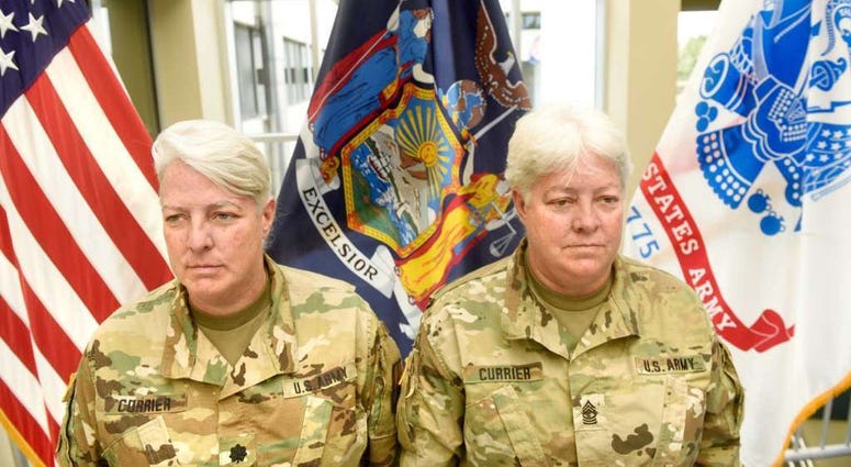 Lt. Col. Lynn Currier, an information management branch manager, and Master Sgt. Lisa Currier, a senior logistics officer, assigned to the New York National Guard Headquarters here, prepare for Lynn's retirement from the New York National Guard during a c Lt. Col. Lynn Currier, an information management branch manager, and Master Sgt. Lisa Currier, a senior logistics officer, assigned to the New York National Guard Headquarters here, prepare for Lynn's retirement from the New York National Guard during a c