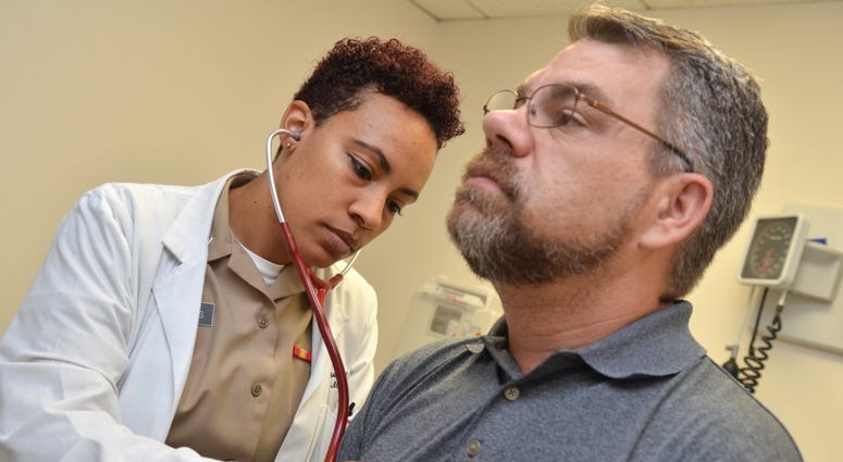 Lt. Taylor James, a physician at Naval Hospital Jacksonville’s Family Medicine Clinic, checks retired Navy Chief Mike Misiak’s heart. NavyHospital