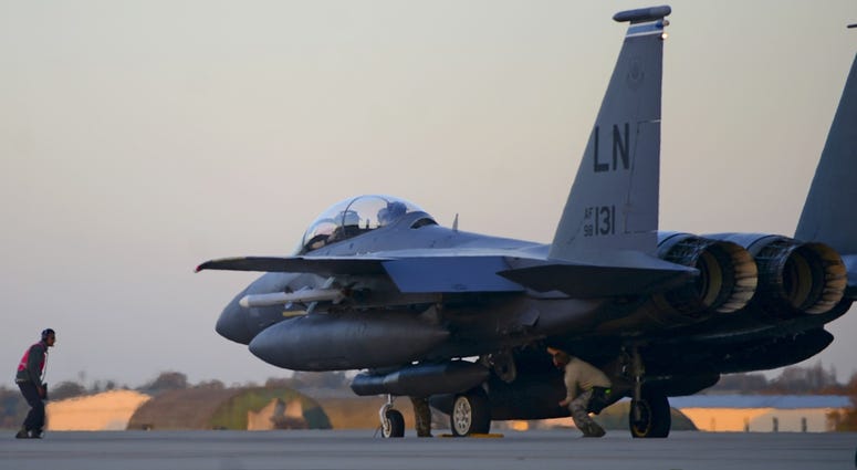 Maintainers inspect an F-15 E Strike Eagle before departure from RAF Lakenheath in support of Operation Inherent Resolve, Nov. 12, 2015.