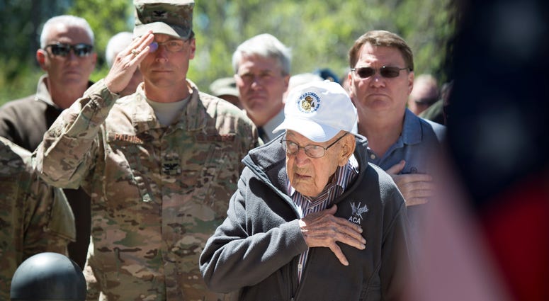 Retired Lt. Col. Richard E. Cole stands for the national anthem during a building renaming and dedication ceremony at Hurlburt Field, Fla., April 7, 2017. The 319th Special Operations Squadron building was renamed after Cole in honor of his career as an e Doolittle Raider