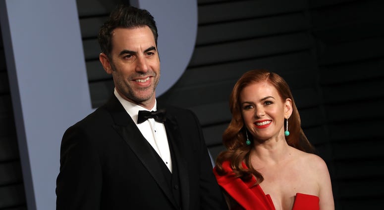 acha Baron Cohen (L) and actress Isla Fisher walking on the red carpet at the 2018 Vanity Fair Oscar Party hosted by Radhika Jones held at the Wallis Annenberg Center for the Performing Arts in Beverly Hills on March 4, 2018.