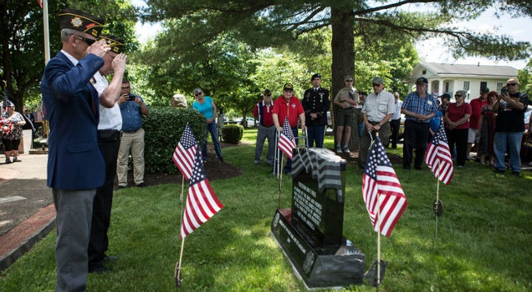 Marine Buck Hopkins and Jim Haskins from the United States Air Force salute a memorial at Veterans Park in Newark, NJ. Memorial Day weekend across America.