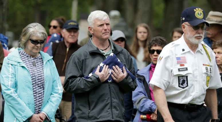 A Gold Star family carries the American Flag at the beginning of the Moment of Remembrance ceremony in Appleton, Wisconsin. Memorial Day weekend across America.