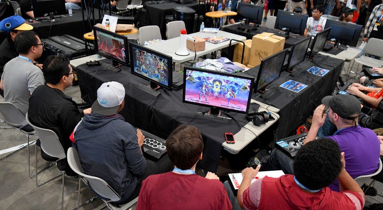 Video gamers play various fighting games as they compete during the first day of the EVO championship series at Las Vegas Convention Center