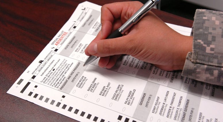 A Joint Task Force Guantanamo Trooper fills out an absentee ballot for the upcoming presidential election, Oct. 8, 2008. Voting