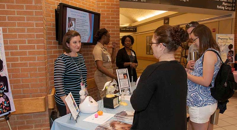 Portsmouth, Va. (June 9, 2017) Heather McFarland, left, an outpatient lactation consultant with the Pediatrics Clinic, speaks with a patient about lactation consultant services during the Pregnancy Fair at Naval Medical Center Portsmouth. The Women’s Hea