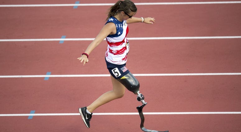 Air Force Captain Christy Wise checks the fitting of her prosthetic leg while running a sprint during the 2017 Invictus Games in Toronto, Canada Sept. 24, 2017. WomanVeteranProsthetic