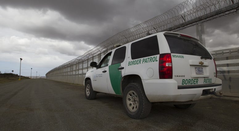 A Border Patrol vehicle sits along the border fence line separating San Diego and Tijuana Mexico watching for illegal crossings in March 2016.