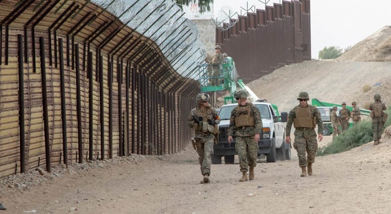 U.S. Marines with the 7th Engineer Support Battalion, Special Purpose Marine Air-Ground Task Force 7, walk along the California-Mexico border at the Andrade Point of Entry in Winterhaven, California, Nov.30, 2018. U.S.